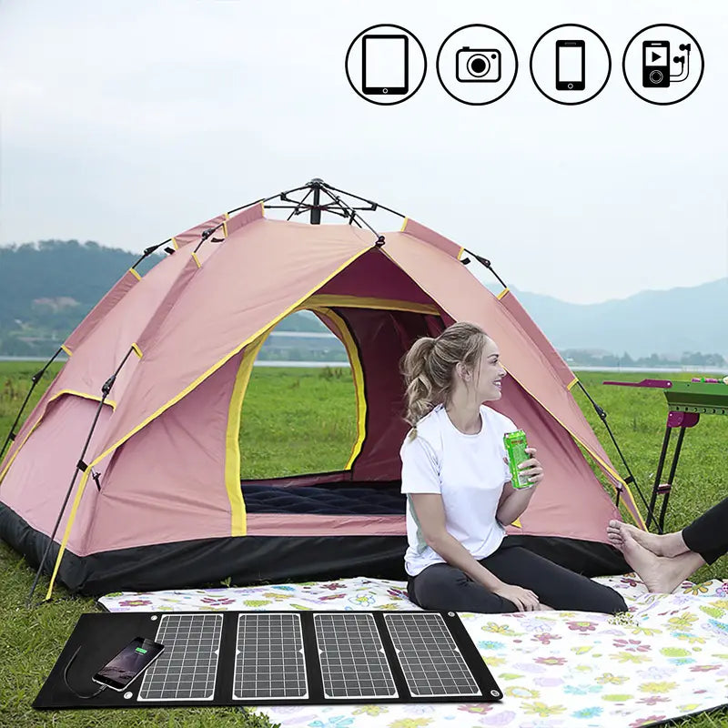 Woman enjoying a drink outside a tent with a Portable Solar Charger for hiking and camping next to her, showcasing outdoor lifestyle.